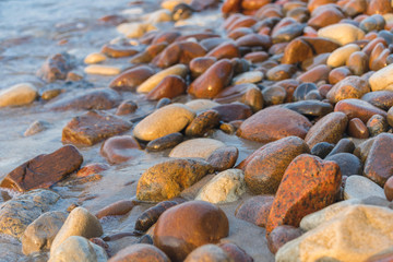 azure waves on a stony beach under the sun