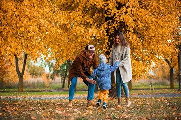 family on autumn walk.photo of a young family