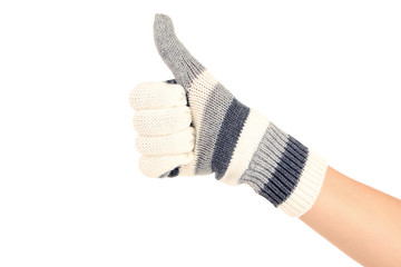 Hand in knitted mitten showing thumb up on white background