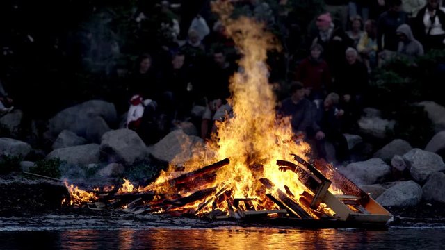 Medium Shot of Midsummer Pyre with High Flames Burning at the Bank of a Lake