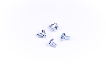 four silver colored screws on white background. screws used for computer hardware.