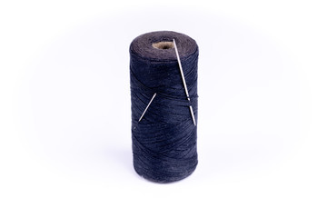 a needle with a thread on a white background.
