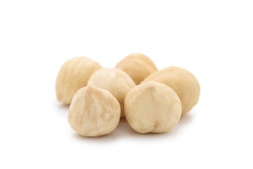 Peeled hazelnuts on isolated white background