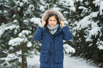 portrait of a beautiful caucasian girl on a background of snow-covered Christmas trees