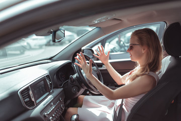 woman driving car, screaming cursing, accident negative incident on road, parking shopping center, summer city. Concept stress negative bad mood, emotions surprise, conflict driving.