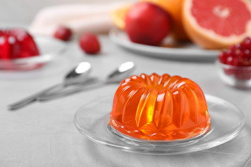 Delicious fresh orange jelly on grey table