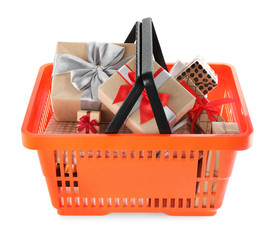 Fototapeta premium Orange shopping basket with different gifts on white background