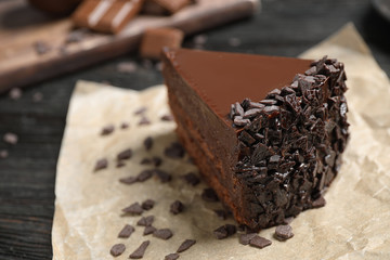 Delicious fresh chocolate cake on wooden table, closeup