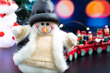 Close-up of snowman in foreground, Christmas holiday background concept with toys, decorations