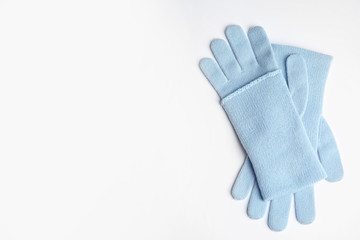 Stylish blue gloves on white background, top view with space for text. Autumn clothes