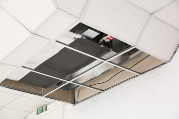 Ceiling mounted air conditioner indoors. Repair and maintenance