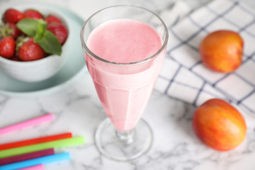 Tasty milk shake on white marble table