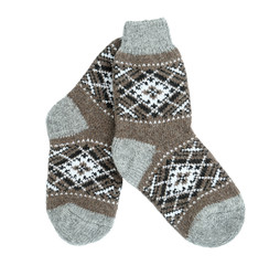 Knitted socks on white background, top view