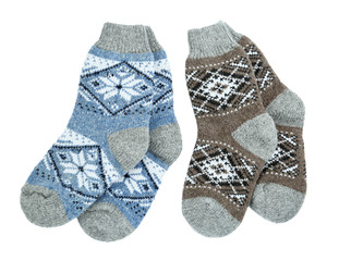 Different knitted socks on white background, top view