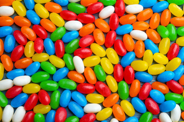 Colorful jelly beans as background, top view