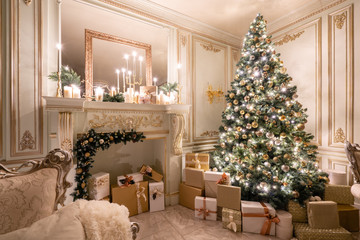 Christmas evening in the light of candles and garlands. Classic luxurious apartments with decorated...
