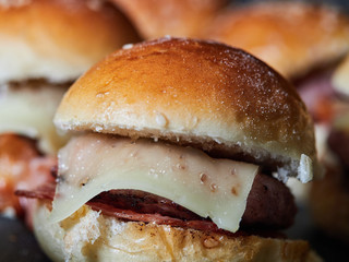 several Minicheeseburguers on black slate stone