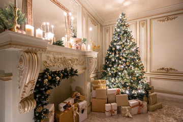 Christmas evening in the light of candles and garlands. Classic luxurious apartments with decorated...