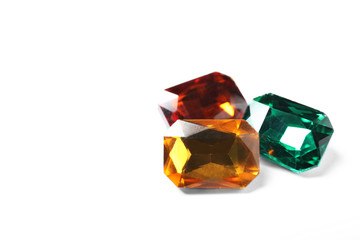 Different beautiful bright gemstones on white background