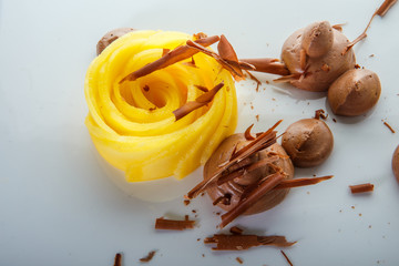 macro view on originally decorated fruit and chocolate mousse dessert