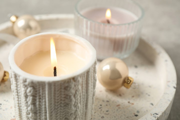 Fototapeta na wymiar Tray with candles and Christmas decor, closeup