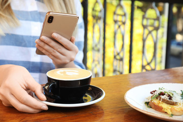 Food blogger taking photo of her lunch at cafe, closeup