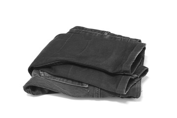Stack of various blue jeans on white background.