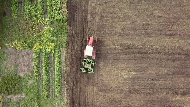 Tractor plows agricultural field. 4K video, 240fps, 2160p.