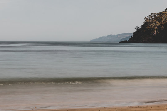 long exposure shot of pristine deserted Australian beach at dusk in Tasmania with moody tones