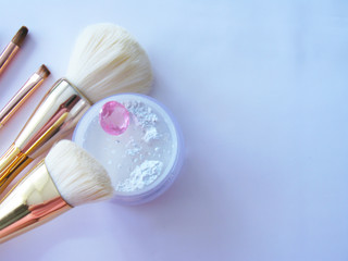 Makeup gold and white powder on a white background