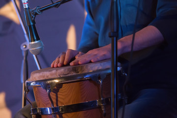 Drummer playing a drum at a concert