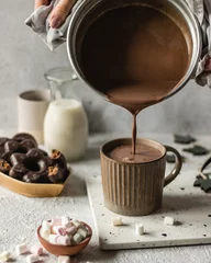 Fotobehang Chocolade Cup of hot chocolate poured on bright background with cookies and marshmllow  © Svitlana