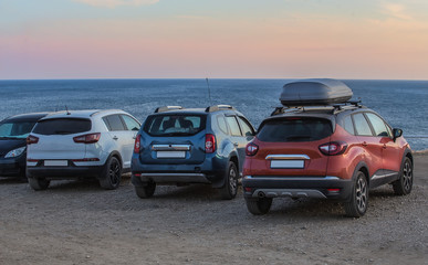 Fototapeta na wymiar Cars on a sandy beach