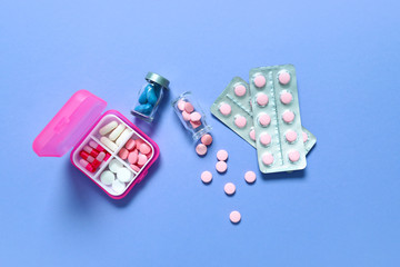 Different pills on color background