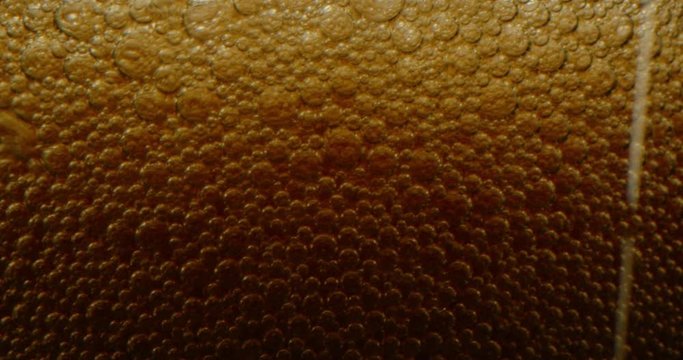 Filling up a cup with Coca-Cola close up. macro shot of bubbles in soda, red epic, drops of water flowing down the glass, sizzling foam drink