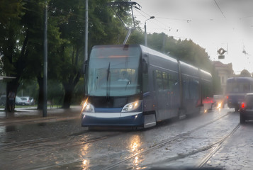 Fototapeta premium modern tram moves along a city street