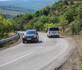 Cars move along a winding road