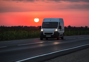 Obraz na płótnie Canvas Minibus moves at dusk at dawn
