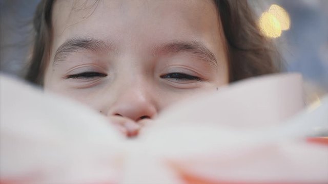 Interesting timelapse video of pretty kid stealing a gift box from under the christmas tree at night.