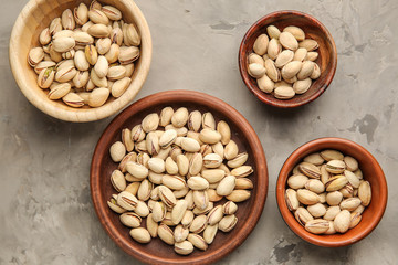 Tasty pistachio nuts on grunge background