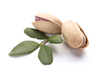 Tasty pistachio nuts on white background