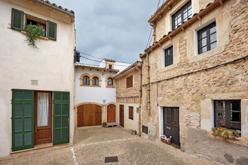 Fototapeta na wymiar Scenic courtyard in old residential neighborhood. Village Capdepera, island Majorca, Spain.
