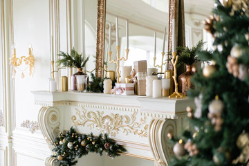 Christmas morning. Classic luxurious apartments with decorated christmas tree and presents. Living with fireplace, columns and stucco.