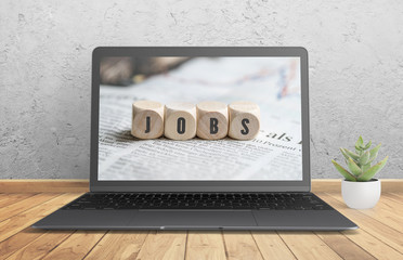 computer with an image of cubes with the word "JOBS"