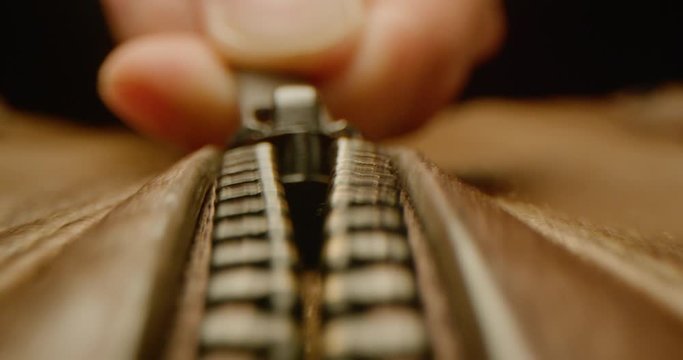 Close up of zipping up a leather jacket, macro shot of zipper on brown leather bag, everyday task, dramatic look, red epic