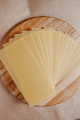 Lasagna sheets, durum wheat pasta on a wooden surface.