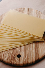 Obraz na płótnie Canvas Lasagna sheets, durum wheat pasta on a wooden surface.