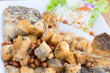 Deep fried batter fish served with vegetables 