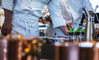 Traditional preparing food and professional Chinese cooks at kitchen.