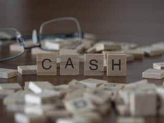 The concept of Cash represented by wooden letter tiles